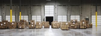 Cardboard boxes at loading dock in warehouse